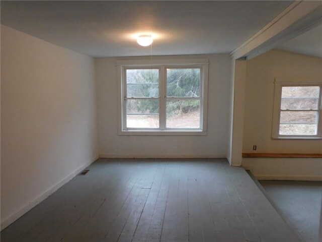 empty room with baseboards and hardwood / wood-style flooring