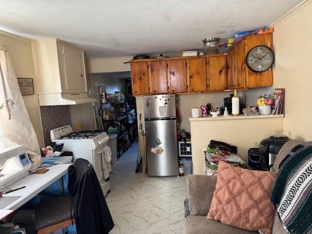kitchen with brown cabinets, marble finish floor, white gas range oven, freestanding refrigerator, and light countertops