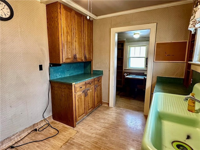 7 Hedgehog Ln, Bradford-Town, PA 16701 - kitchen with brown cabinets, crown molding, light wood-style floors, wallpapered walls, and dark countertops