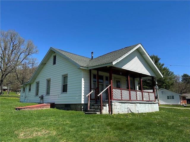 7 Hedgehog Ln, Bradford-Town, PA 16701 - view of front of home with covered porch, a front lawn, and a shingled roof