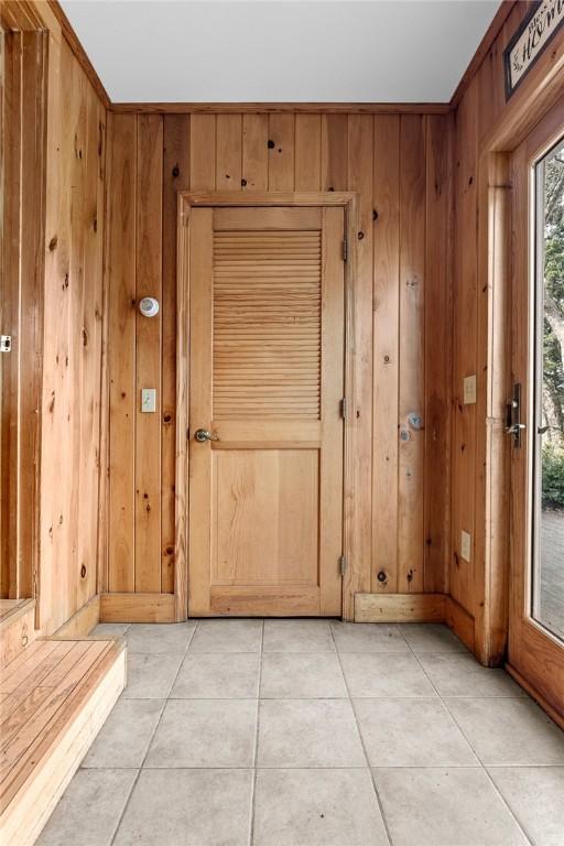 7317 County Highway 33, Kortright, NY 13739 - doorway featuring light tile patterned floors and wood walls
