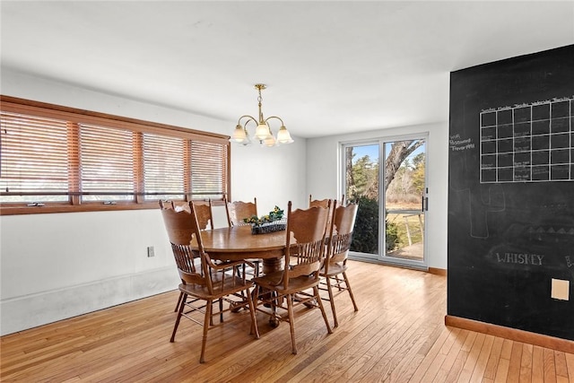 7317 County Highway 33, Kortright, NY 13739 - dining area featuring an inviting chandelier, light wood-style flooring, and baseboards