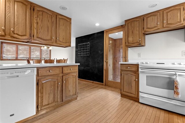 7317 County Highway 33, Kortright, NY 13739 - kitchen with light countertops, recessed lighting, light wood-style floors, brown cabinetry, and white appliances