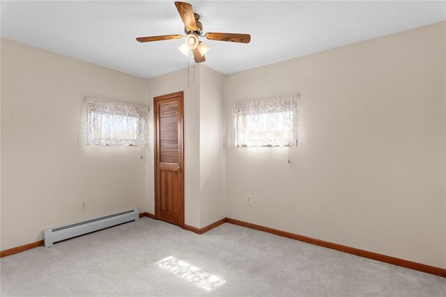 7317 County Highway 33, Kortright, NY 13739 - empty room featuring light carpet, baseboards, a baseboard heating unit, and ceiling fan