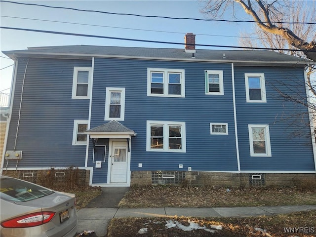 view of front facade featuring a chimney