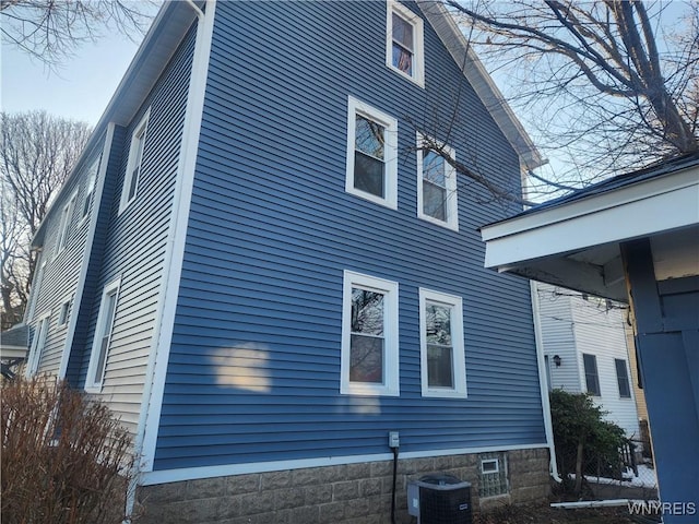 view of side of home featuring central AC unit