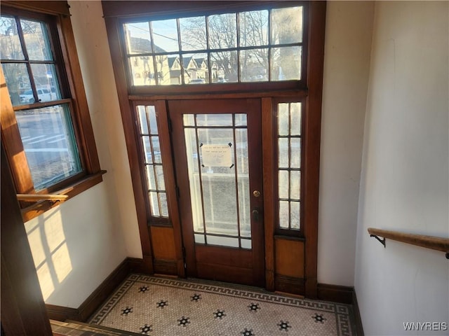 foyer featuring tile patterned floors and baseboards
