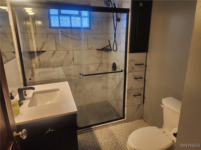 full bathroom featuring vanity, toilet, and a stall shower