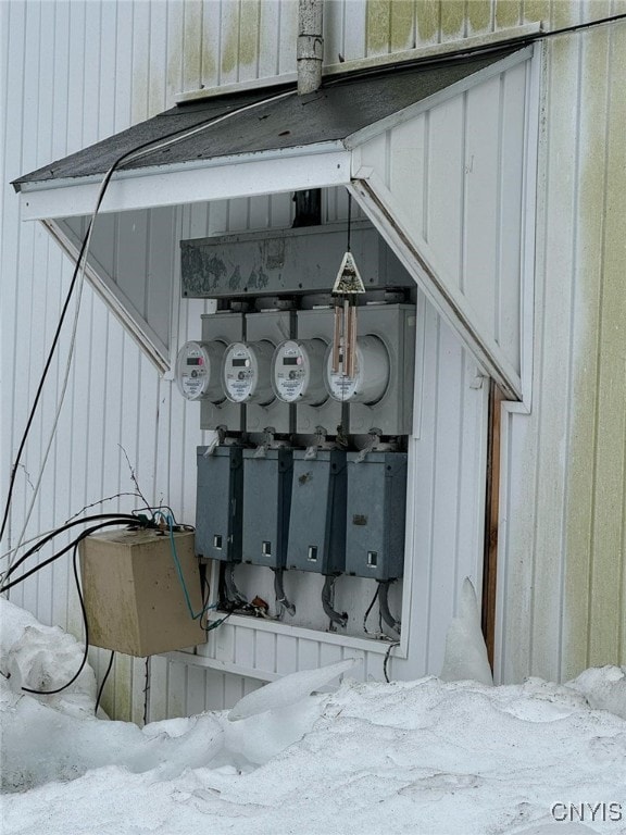 163 E 9th St, Oswego-City, NY 13126 - exterior details featuring board and batten siding, electric panel, and electric meter