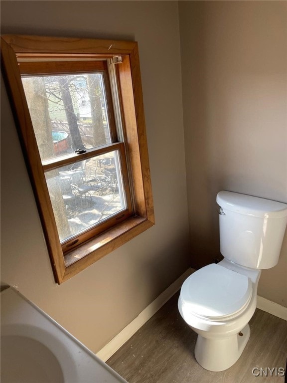 163 E 9th St, Oswego-City, NY 13126 - bathroom with toilet, baseboards, and wood finished floors