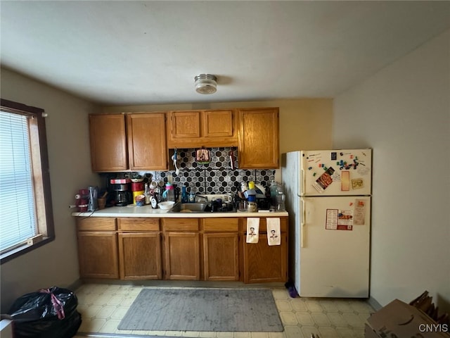 163 E 9th St, Oswego-City, NY 13126 - kitchen featuring freestanding refrigerator, light floors, brown cabinets, and light countertops