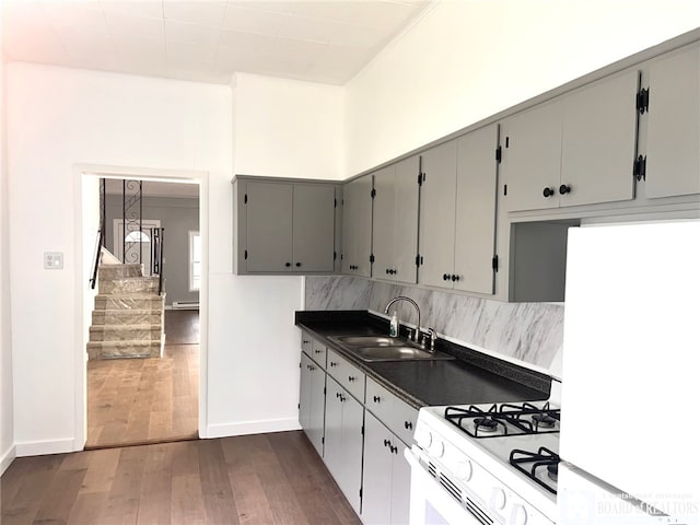 298 S Main St, Jamestown, NY 14701 - kitchen featuring white appliances, dark wood-style floors, a sink, dark countertops, and tasteful backsplash