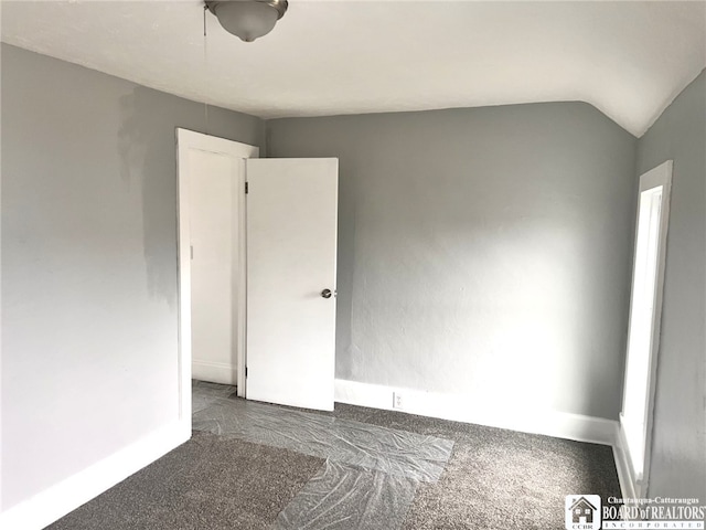 298 S Main St, Jamestown, NY 14701 - carpeted spare room with baseboards and vaulted ceiling