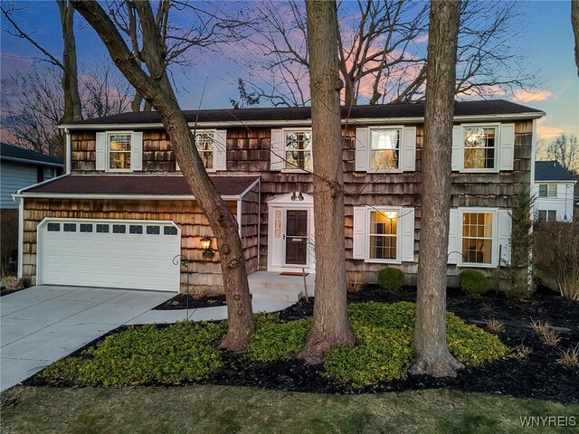 view of front of property featuring concrete driveway and an attached garage