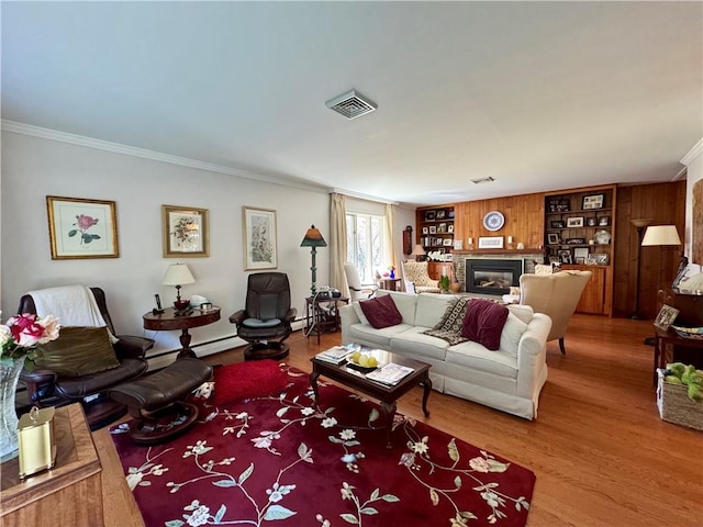 4 Ravine Park N, Oneonta-City, NY 13820 - living room featuring ornamental molding, a glass covered fireplace, wood finished floors, and a baseboard heating unit