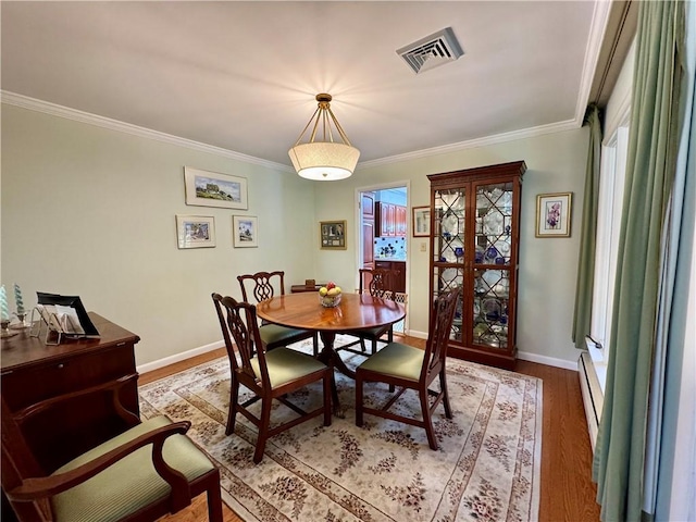 4 Ravine Park N, Oneonta-City, NY 13820 - dining space with ornamental molding, wood finished floors, and plenty of natural light