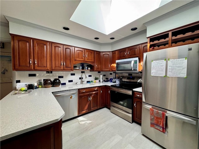 4 Ravine Park N, Oneonta-City, NY 13820 - kitchen with appliances with stainless steel finishes, a peninsula, a skylight, decorative backsplash, and ornamental molding