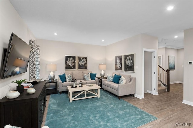 living area with stairway, recessed lighting, baseboards, and wood finished floors