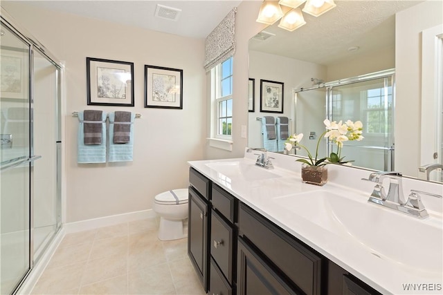 bathroom with tile patterned flooring, a stall shower, visible vents, and a sink