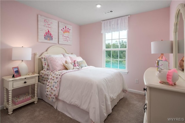 carpeted bedroom featuring baseboards and visible vents