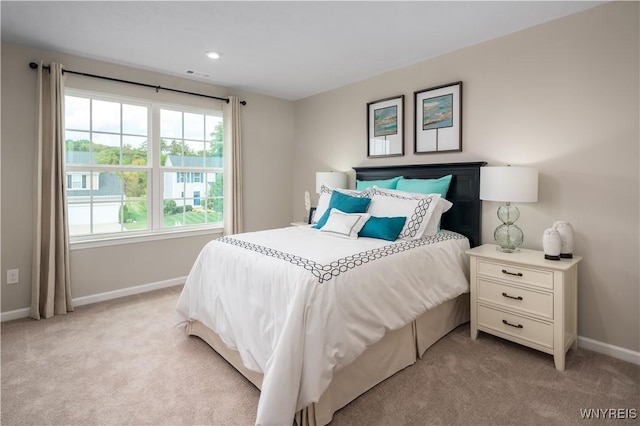bedroom featuring light carpet, visible vents, recessed lighting, and baseboards