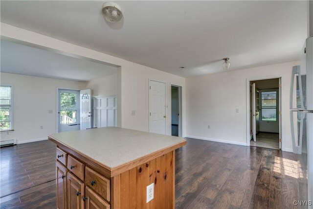 36194 State Route 180, Orleans, NY 13656 - kitchen featuring brown cabinets, a kitchen island, baseboards, and dark wood-style flooring