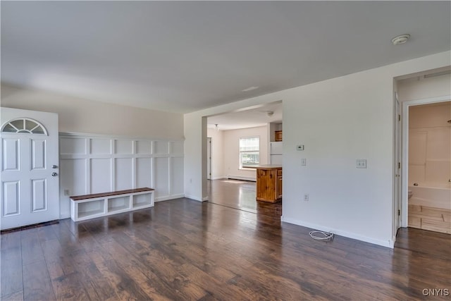 36194 State Route 180, Orleans, NY 13656 - unfurnished living room with baseboards and dark wood-style flooring
