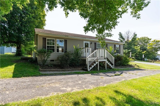 view of front of home featuring stairs, a front lawn, and crawl space