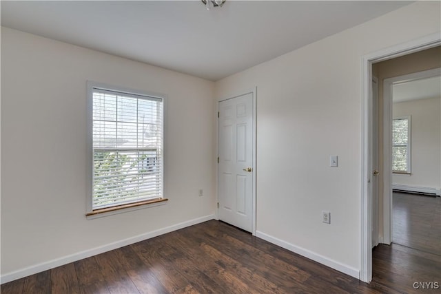36194 State Route 180, Orleans, NY 13656 - unfurnished bedroom featuring dark wood-style floors, a baseboard heating unit, and baseboards