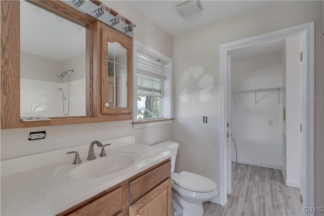 36194 State Route 180, Orleans, NY 13656 - bathroom with visible vents, toilet, wood finished floors, baseboards, and vanity