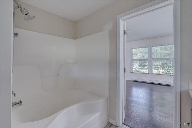 36194 State Route 180, Orleans, NY 13656 - bathroom with baseboard heating, shower / washtub combination, and wood finished floors