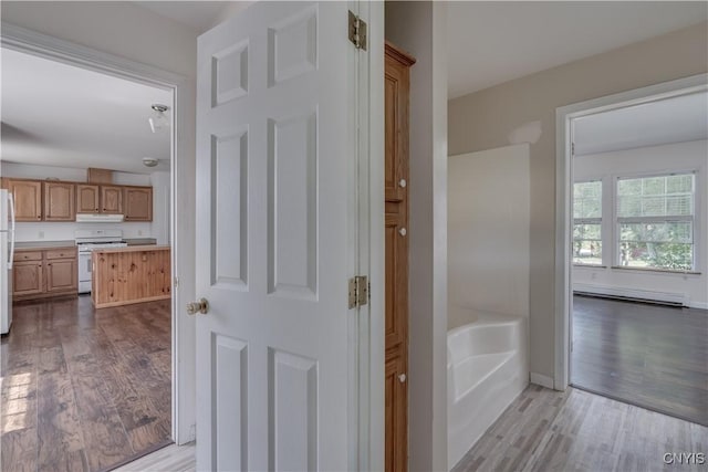 36194 State Route 180, Orleans, NY 13656 - corridor featuring a baseboard radiator, baseboards, and dark wood-style flooring