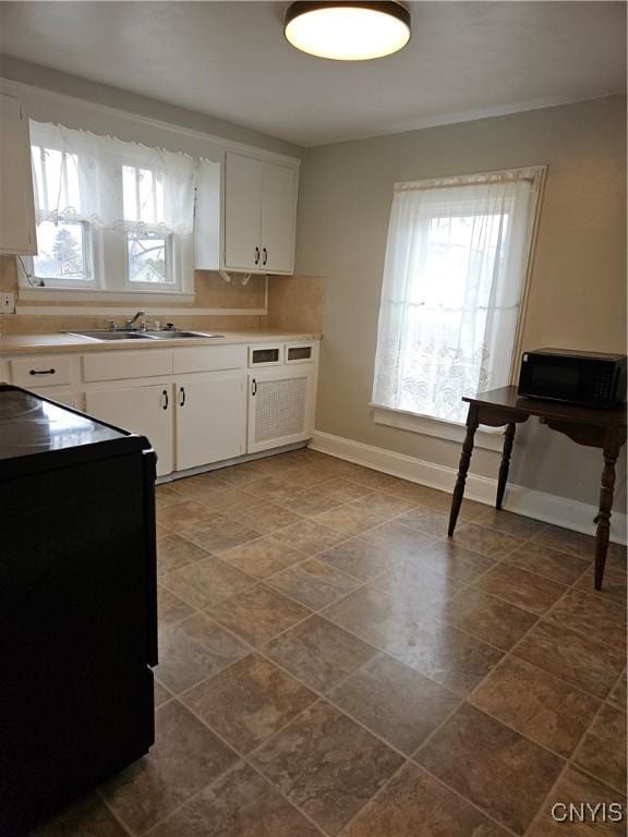 220 Odell Ave, Union, NY 13760 - kitchen featuring white cabinetry, baseboards, a wealth of natural light, and a sink