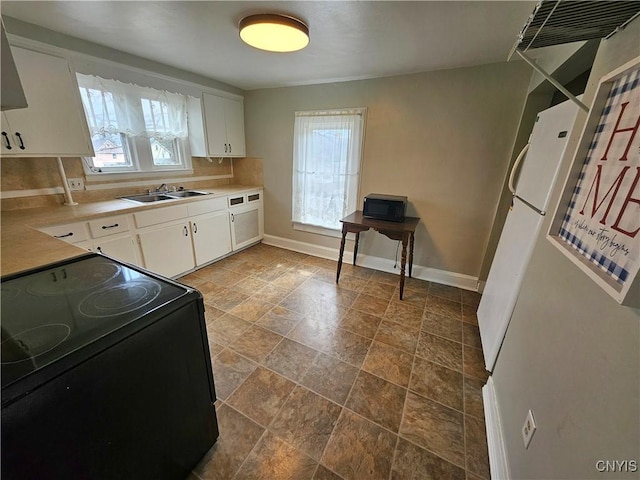 220 Odell Ave, Union, NY 13760 - kitchen with white cabinetry, black range with electric stovetop, baseboards, and a sink