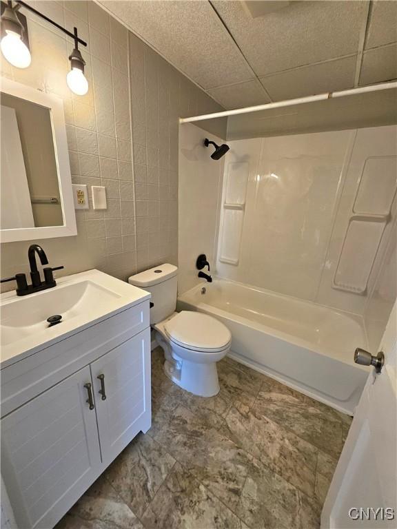 220 Odell Ave, Union, NY 13760 - full bathroom featuring shower / bath combination, toilet, tile walls, and vanity