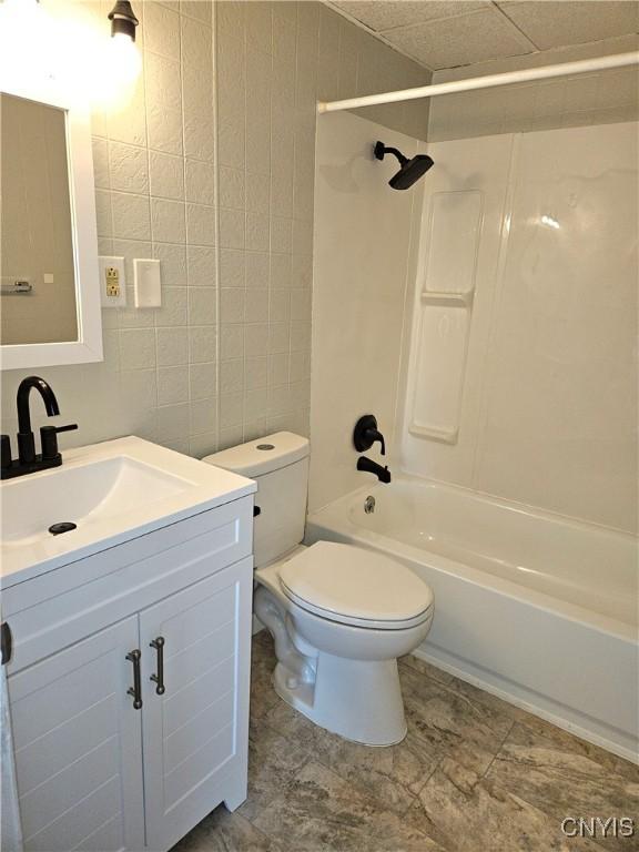 220 Odell Ave, Union, NY 13760 - full bath with vanity, shower / tub combination, toilet, and tile walls