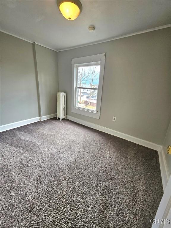 220 Odell Ave, Union, NY 13760 - unfurnished room with dark colored carpet, baseboards, radiator, and ornamental molding