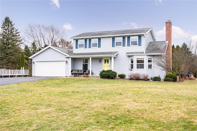 view of front of property with aphalt driveway, a garage, a chimney, and a front lawn
