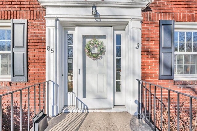 property entrance featuring brick siding