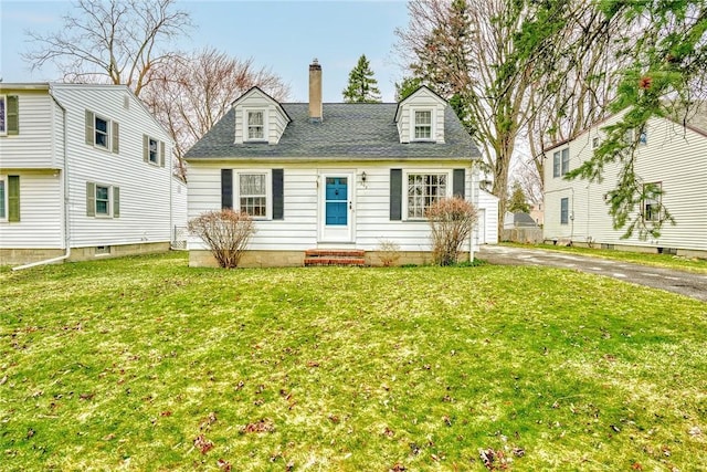 cape cod home with entry steps, a chimney, a front lawn, and roof with shingles