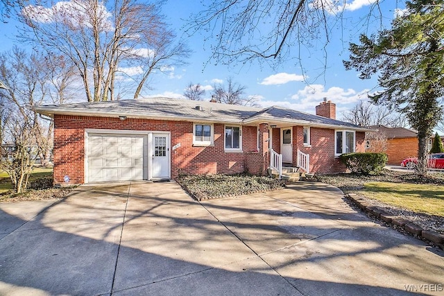 ranch-style house with brick siding, a chimney, concrete driveway, and a garage