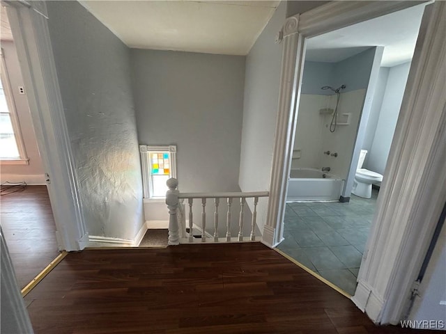 interior space featuring baseboards and wood finished floors