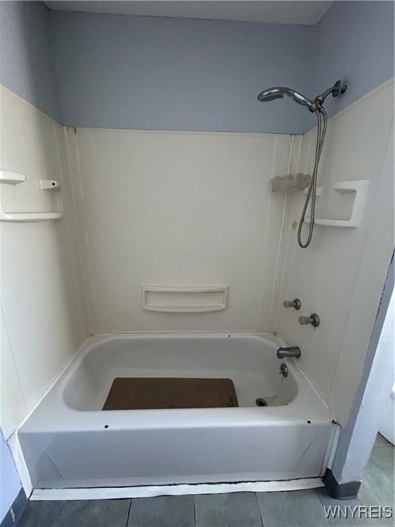 full bath with tile patterned floors and shower / bathing tub combination
