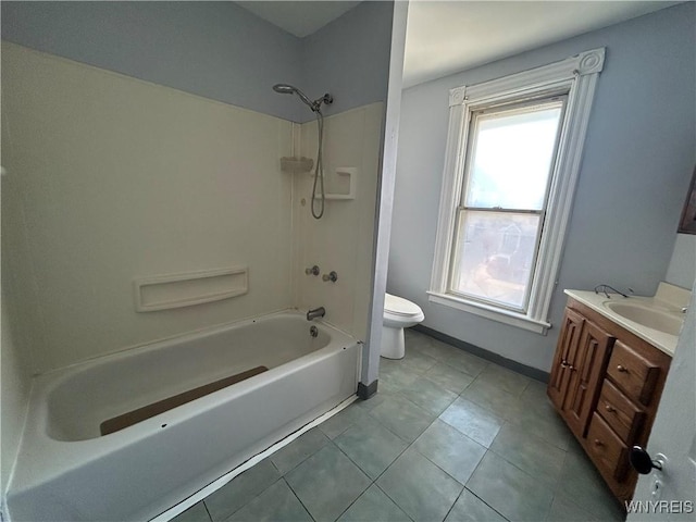 bathroom with tile patterned floors, toilet,  shower combination, baseboards, and vanity