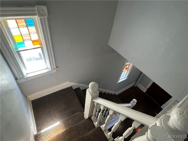 staircase with carpet flooring and baseboards