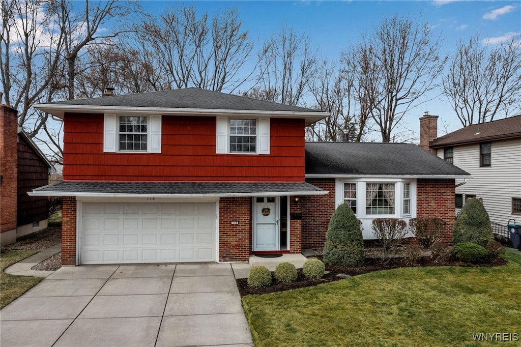 view of front of home with driveway, roof with shingles, a front yard, an attached garage, and brick siding