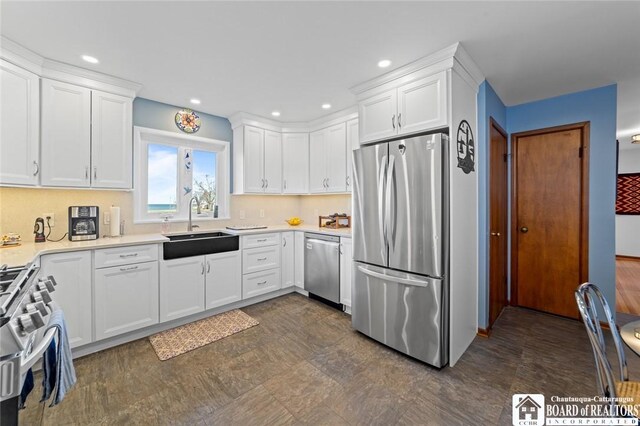 92 E Pine St, Dunkirk-City, NY 14048 - kitchen featuring recessed lighting, a sink, stainless steel appliances, light countertops, and white cabinetry