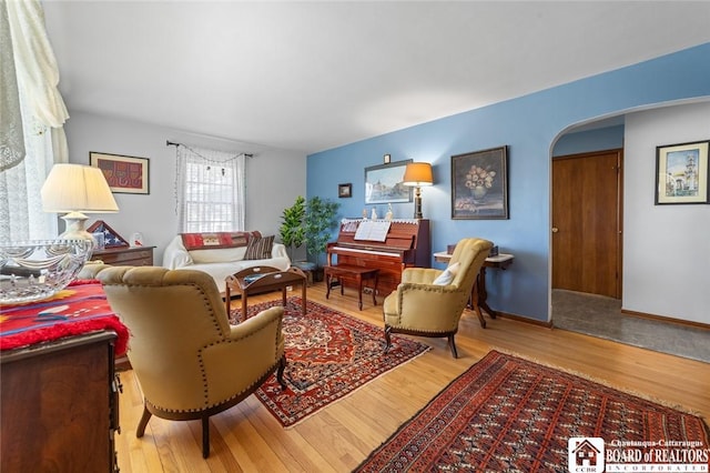 92 E Pine St, Dunkirk-City, NY 14048 - living area featuring wood finished floors, arched walkways, and baseboards