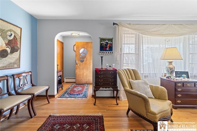 92 E Pine St, Dunkirk-City, NY 14048 - sitting room with arched walkways, a baseboard heating unit, and wood finished floors