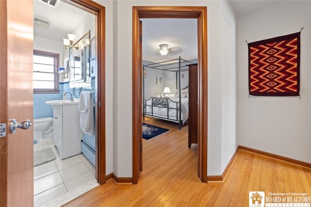 92 E Pine St, Dunkirk-City, NY 14048 - hall with a sink, baseboards, and light wood-style floors